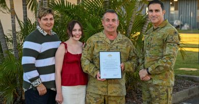 Major Brian Moore receives his Federation Star from Chief of Army Lieutenant General Simon Stuart, right, in the presence of family members. Story and photo by Major Carolyn Barnett.