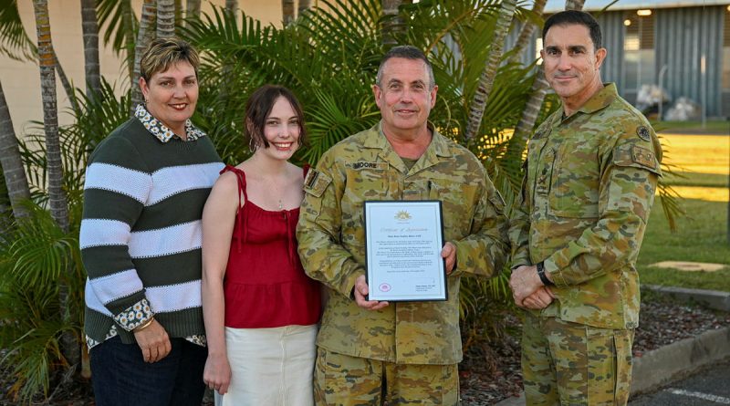 Major Brian Moore receives his Federation Star from Chief of Army Lieutenant General Simon Stuart, right, in the presence of family members. Story and photo by Major Carolyn Barnett.