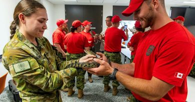 Australian Army soldier Private Kaitlyn Gallagher, left, hands over a juvenile saltwater crocodile to a soldier from 4th Canadian Ranger Patrol Group during the Exercise Southern Cross 2025 fauna workshop in Darwin. Story by Captain Tim Klingner. Photos by Corporal Michael Currie.