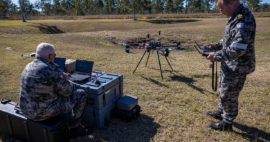 Commander Andrew Watson, left, and Chief Petty Officer Simon Hustwit prepare the Callisto 50 logistics drone for flight during a trial phase at Exercise Talisman Sabre. Story and photo by Corporal Michael Rogers.