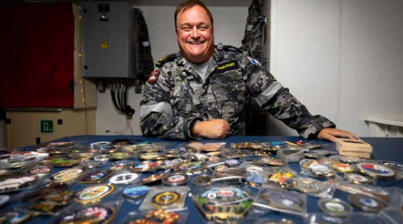 Leading Seaman Adam Hamburger with the impressive trove of coins he collected during HMAS Sydney's regional presence deployment in the Indo-Pacific region. Story by Lieutenant Hinako Shiraishi. Photo by Leading Seaman David Cox.