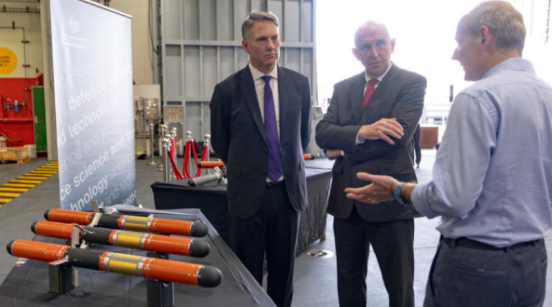 Australian Deputy Prime Minister and Defence Minister Richard Marles and UK Secretary of State for Defence John Healey with Dr Michael Sharp at a Defence Science and Technology Group display on board HMS Prince of Wales. Photo by Jay Cronan.