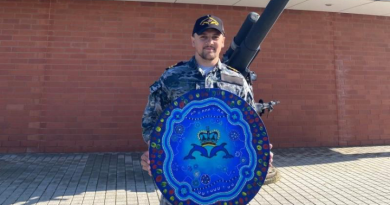 Lieutenant Steven Taylor holds his artwork designed for the Submarine Training and Systems Centre at HMAS Stirling. Story by Chief Petty Officer Maryanne Rowbottom. Photo supplied.