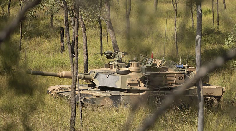 An Australian Army M1A2 Abrams main battle tank from the 2nd Cavalry Regiment during a live-fire practice in the Townsville Field Training Area during Exercise Eagle March. Photo by Sergeant Matthew Bickerton.