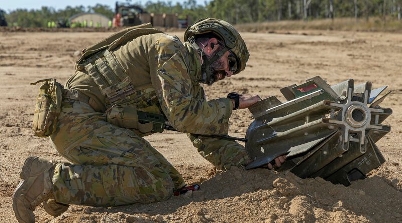 Royal Australian Air Force (RAAF) Corporal Matthew Vella, an explosive ordnance disposal assistant from 65 Air Base Recovery Squadron (65ABRS), assesses a Mark 82 bomb with a snake eye tail fin at airstrip at the Townsville Field Training Area. Story by Flight Lieutenant Sharon Sebastian. Photos by Corporal Brett Sherriff.