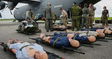 Clinicians from the Royal Australian Air Force (RAAF), Royal New Zealand Air Force (RNZAF), Royal Air Force (RAF), United States Air Force (USAF) and Royal Canadian Air Force (RCAF) lay out medical dummies for an aero-medical evacuation during Exercise Mobility Guardian. Story by Flight Lieutenant Kayla Walliss. Photo from NZDF.