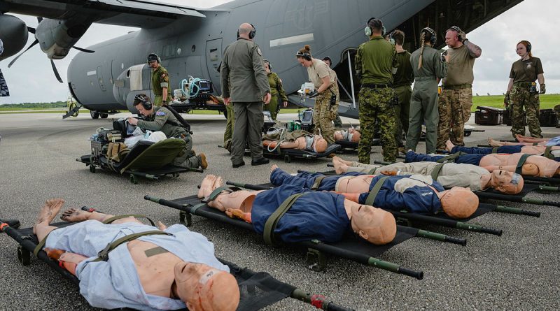 Clinicians from the Royal Australian Air Force (RAAF), Royal New Zealand Air Force (RNZAF), Royal Air Force (RAF), United States Air Force (USAF) and Royal Canadian Air Force (RCAF) lay out medical dummies for an aero-medical evacuation during Exercise Mobility Guardian. Story by Flight Lieutenant Kayla Walliss. Photo from NZDF.