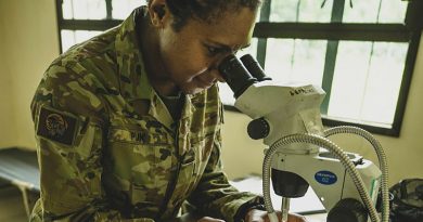 Private Janet Puk, from 4th Health Battalion, examines mosquitoes under the microscope in Fort Magsaysay, Philippines, during Exercise Alon. Story and photos by Sergeant Roger Tang.