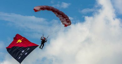 An Australian Army member from the Parachute Training School descend into Sir Hubert Murray Stadium from a PNG Defence Force aircraft during the Military Tattoo at Port Moresby. Story by Captain Katy Manning. Photos by Corporal Jack Pearce.
