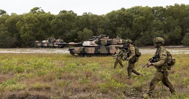 Australian Army soldiers from the 1st Battalion, Royal Australian Regiment, and the 2nd Cavalry Regiment, patrol through Cowley Beach Training Area during the combined arms training activity. Photo by Corporal Brodie Cross.
