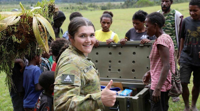 Trooper Megan Creamer helps deliver donated goods during a community outreach activity in the Papua New Guinea Central Highlands village of Kosipe during Exercise Helicon Luk. Story and photos by Captain Tadek Markowski.