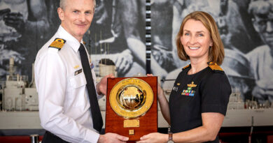 Incoming Commanding Officer HMAS Kuttabul Captain Iain Hutchins, left, receives the weight from outgoing Commanding Officer HMAS Kuttabul Captain Rebecca Levitt at the Heritage Centre, Garden Island, Sydney. Story by By Lieutenant Hinako Shiraishi. Photos by Able Seaman Abdus Chowdhury.