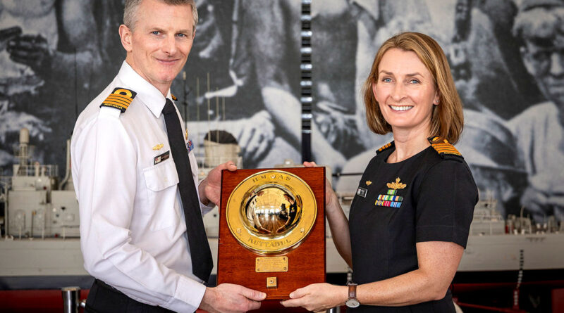 Incoming Commanding Officer HMAS Kuttabul Captain Iain Hutchins, left, receives the weight from outgoing Commanding Officer HMAS Kuttabul Captain Rebecca Levitt at the Heritage Centre, Garden Island, Sydney. Story by By Lieutenant Hinako Shiraishi. Photos by Able Seaman Abdus Chowdhury.