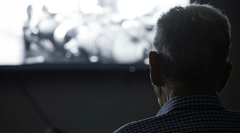 Herbert Adams watches the premiere screening of the documentary, An Enduring Legacy: The Empire Air Training Scheme, at RAAF Base Wagga, NSW. Ssdtory by Squadron Leader Karyn Markwell. Photos by Aircraftman Jakob Reid.