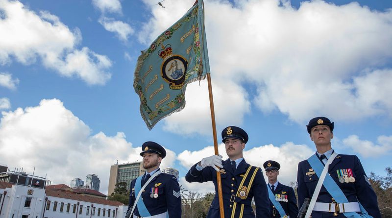 The Colour Party presents the 9 Squadron Standard as a Bell UH-1 Iroquois helicopter conducts a flyover at the Torrens Parade Ground in Adelaide to mark the squadron’s reformation. Story by Flying Officer Shanea Zeegers. Photo by Flight Sergeant Rob Hack.