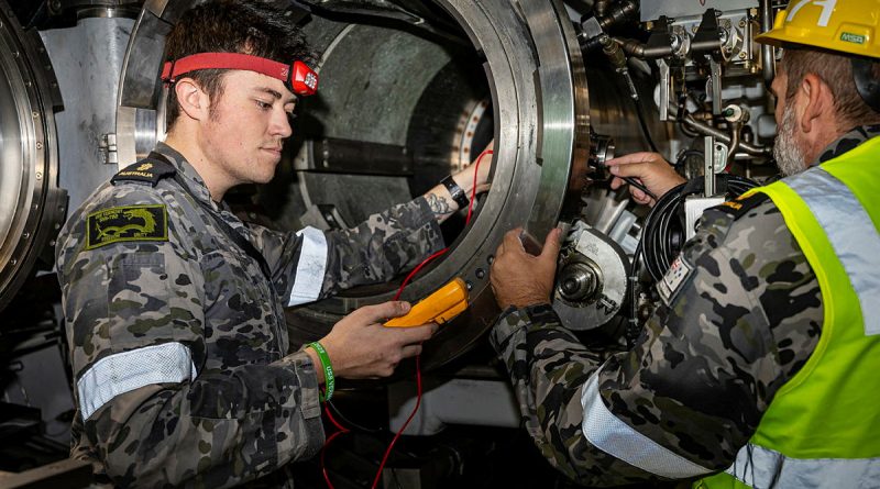 Able Seaman Jack, left, and Able Seaman Thomas Phillips conduct electrical testing on a torpedo tube on board the Virginia-class fast-attack submarine USS Vermont at HMAS Stirling in WA. Story by Lieutenant Mark Tesoriero. Photos by Leading Seaman Shaun Chatfield.