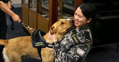 Seaman Charis Zapata gives Australian Border Force dog Magic a well-deserved hug and pat after a morning of training. Story and photos by Sub-Lieutenant Michael Edwards.