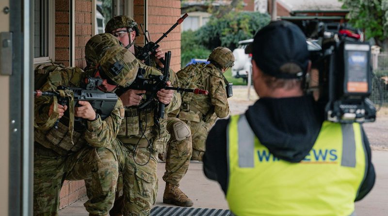A TV crew films Australian soldiers as they conduct clearance operations as part of Exercise Arras Walk. Photo by Captain Mark Blackman.