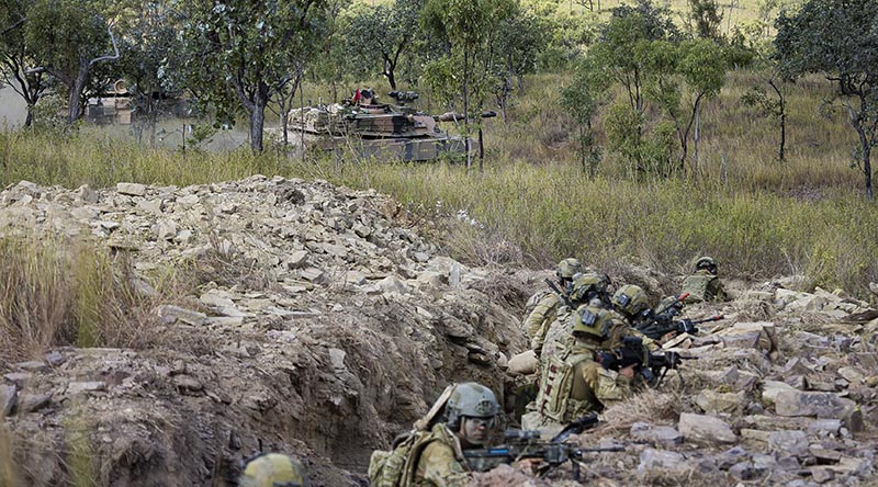 Australian Army soldiers from the 1st Battalion, Royal Australian Regiment, conduct a trench clearance, supported by 2nd Cavalry Regiment M1A1 Abrams main battle tanks, as part of Exercise Brolga Sprint at Townsville Field Training Area, Queensland. Photo by Private Jessica Gray.
