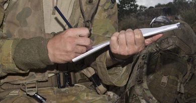 An Aussie soldier writing in the field. Cropped from larger image by Corporal David Cotton.