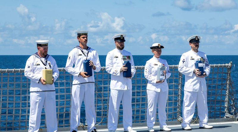 Members of HMAS Ballarat's ship's company prepare to scatter the ashes of four Royal Australia Navy sailors and one Royal Navy sailor during a committal of ashes to the sea ceremony off the coast of Australia. Story by Sub-Lieutenant Jake Badior. Photos by Leading Seaman Connor Morrison.