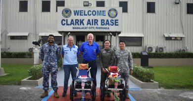 Australian and Philippine Air Force members and representatives of Wheelchairs for Kids and the Angeles City Returned Services League, with two of the wheelchairs delivered to Clark Air Base, Philippines.