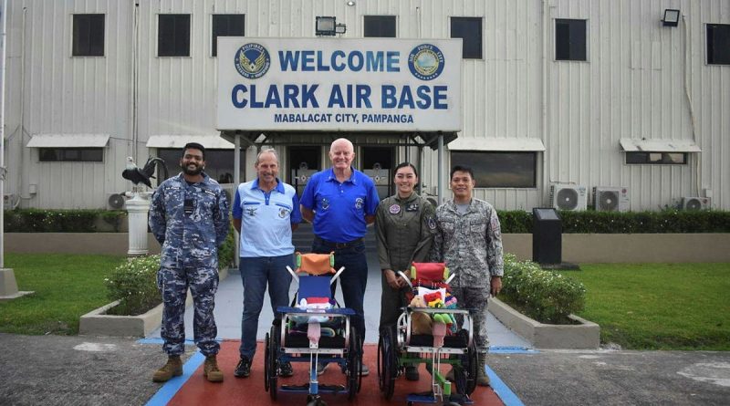 Australian and Philippine Air Force members and representatives of Wheelchairs for Kids and the Angeles City Returned Services League, with two of the wheelchairs delivered to Clark Air Base, Philippines.
