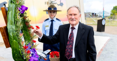 A relative of Flight Lieutenant Ross Frayne – a World War 2 and Korean War veteran who died in a crash at RAAF Base Mallala in 1955 – places a poppy on a commemorative wreath at the new Air Force memorial at the South Australian Aviation Museum. Story by Group Captain Greg Weller.