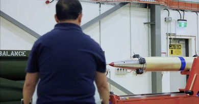 A Lockheed Martin employee handling a HIMARS missile at Port Wakefield. Lockheed Martin video screen grab.