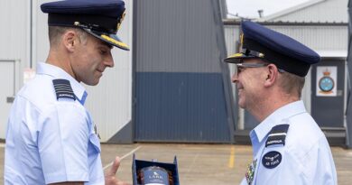 Group Captain Adam Saber gives a farewell gift to outgoing Commander Air Mobility Group, Air Commodore Bradley Clarke at a Change of Command ceremony at RAAF Base Richmond. Photo by Leading Aircraftwoman Mikaela Fernlund.