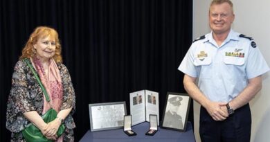 Warrant Officer of the Air Force Warrant Officer Ralph Clifton presents acting Flight Lieutenant Thomas James Carmody’s Australian Service Medal 1939–1945 and War Medal 1939–1945 to Julie Carmody. Photo: Aircraftman Jakob Reid.